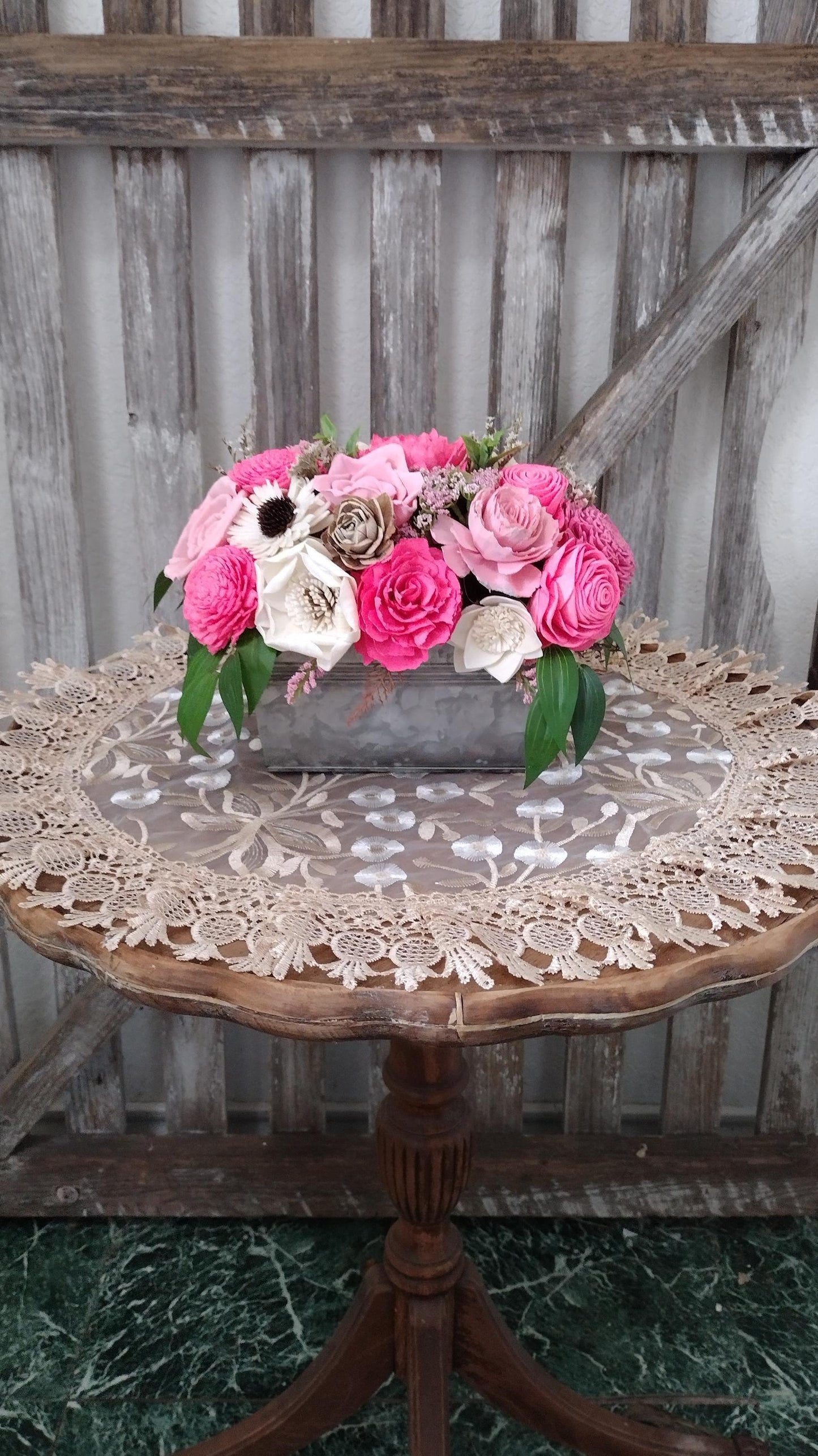 Centerpiece with hand dyed Sola flowers. Beautiful shades of pink wooden florals  in a galvanized container