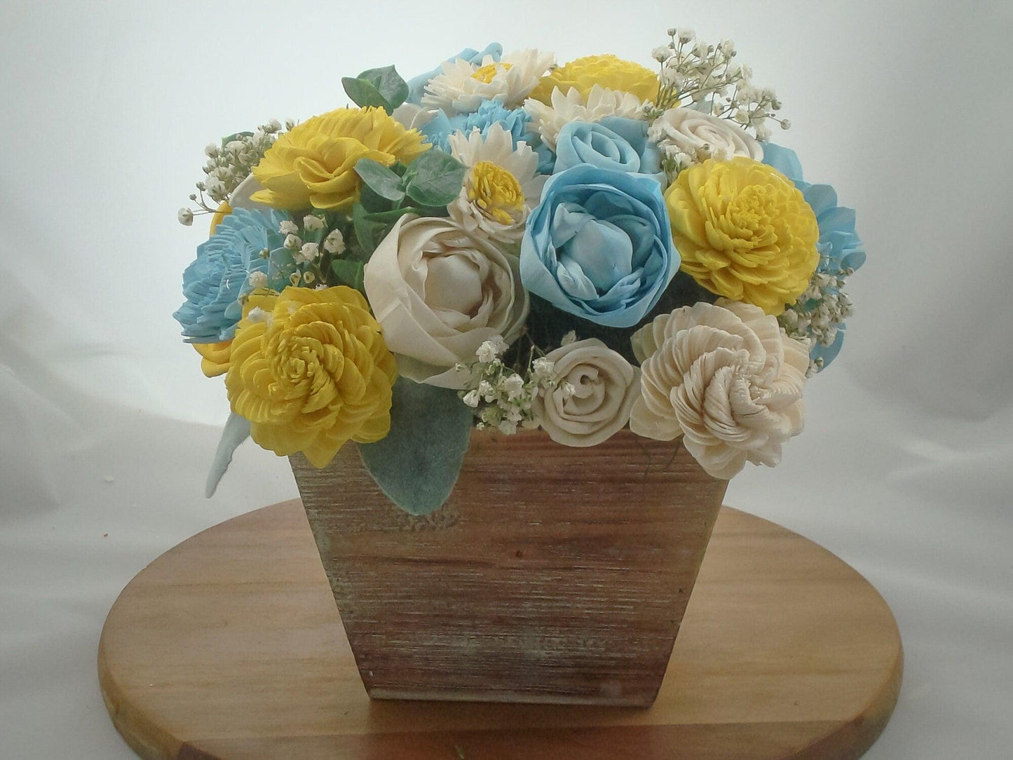 Centerpiece made from Sola flowers in blue and yellow. Perfect for a wedding or your home Keepsake arrangement that lives forever!