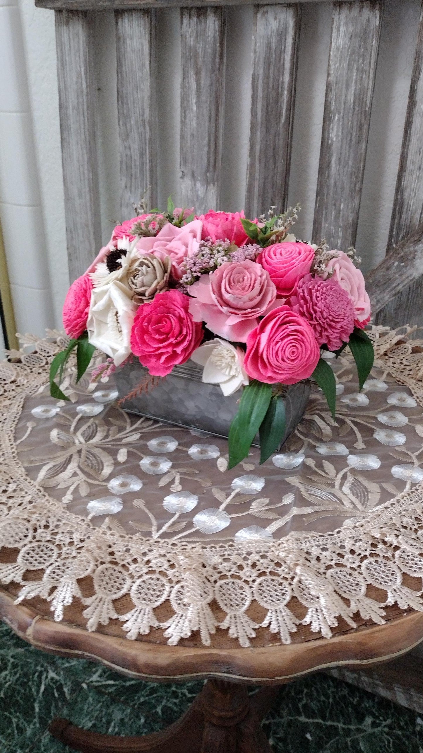 Centerpiece with hand dyed Sola flowers. Beautiful shades of pink wooden florals  in a galvanized container