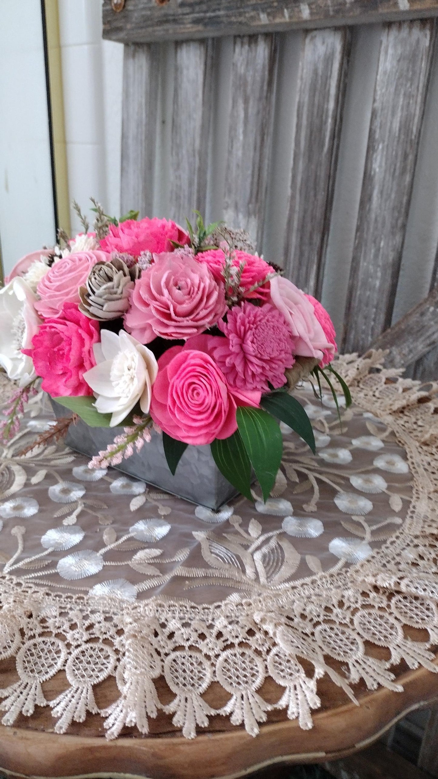 Centerpiece with hand dyed Sola flowers. Beautiful shades of pink wooden florals  in a galvanized container