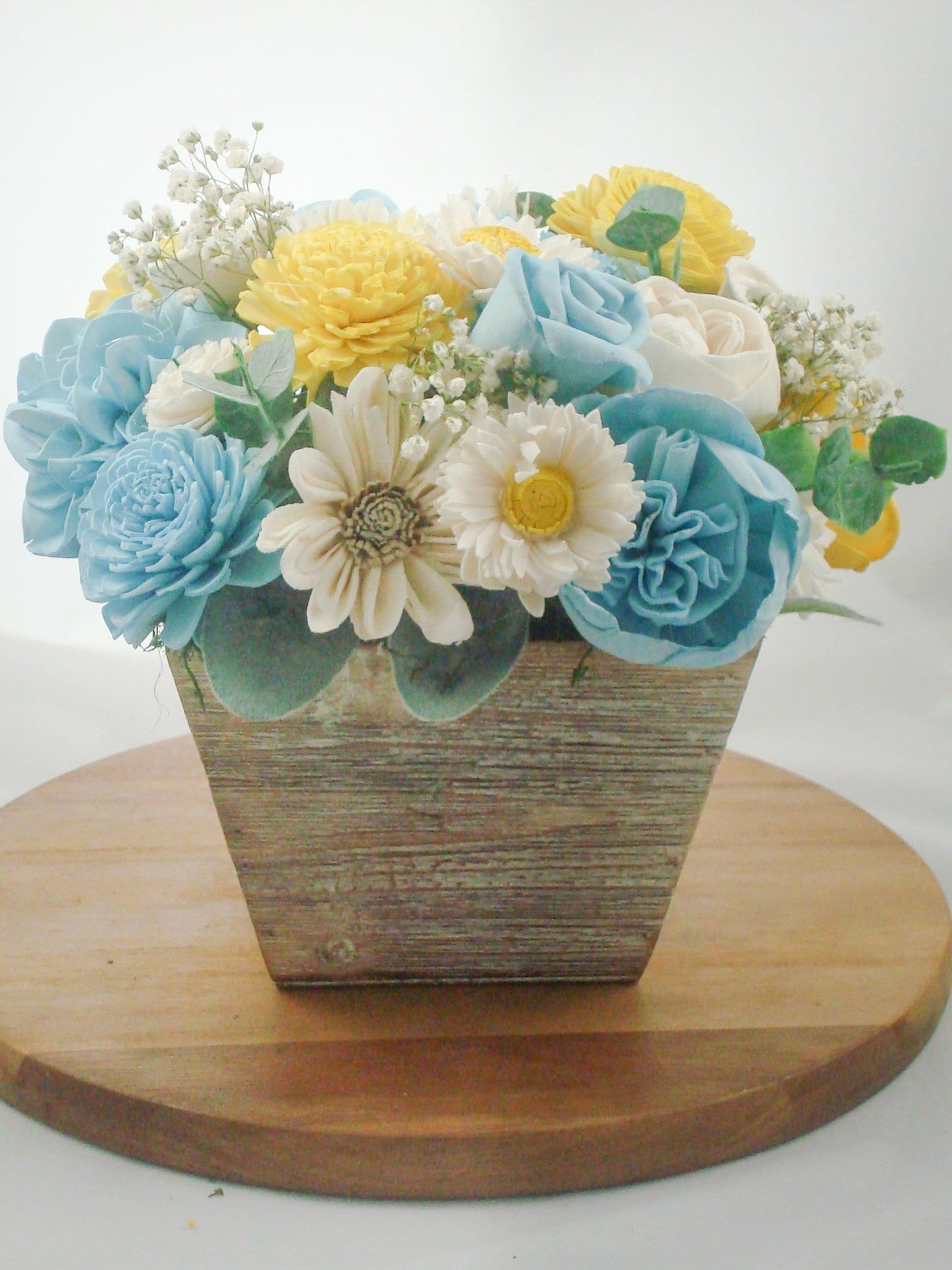 Centerpiece made from Sola flowers in blue and yellow. Perfect for a wedding or your home Keepsake arrangement that lives forever!