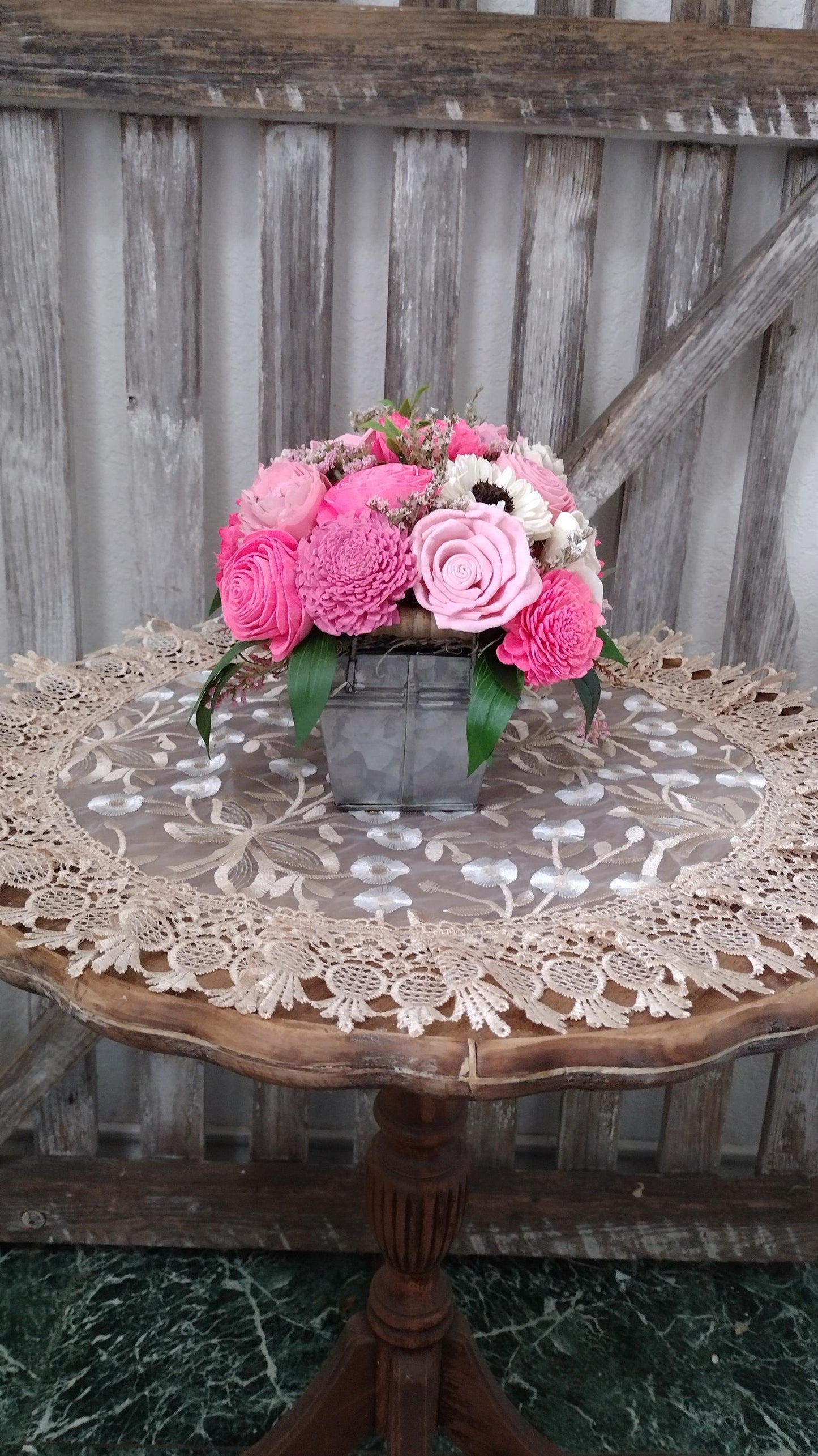 Centerpiece with hand dyed Sola flowers. Beautiful shades of pink wooden florals  in a galvanized container