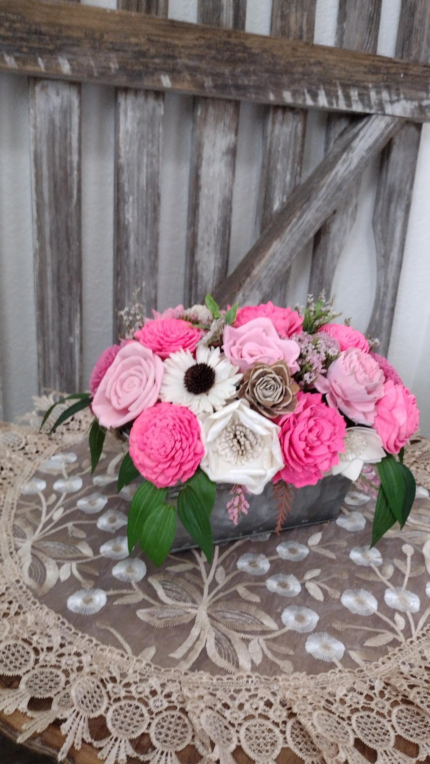 Centerpiece with hand dyed Sola flowers. Beautiful shades of pink wooden florals  in a galvanized container