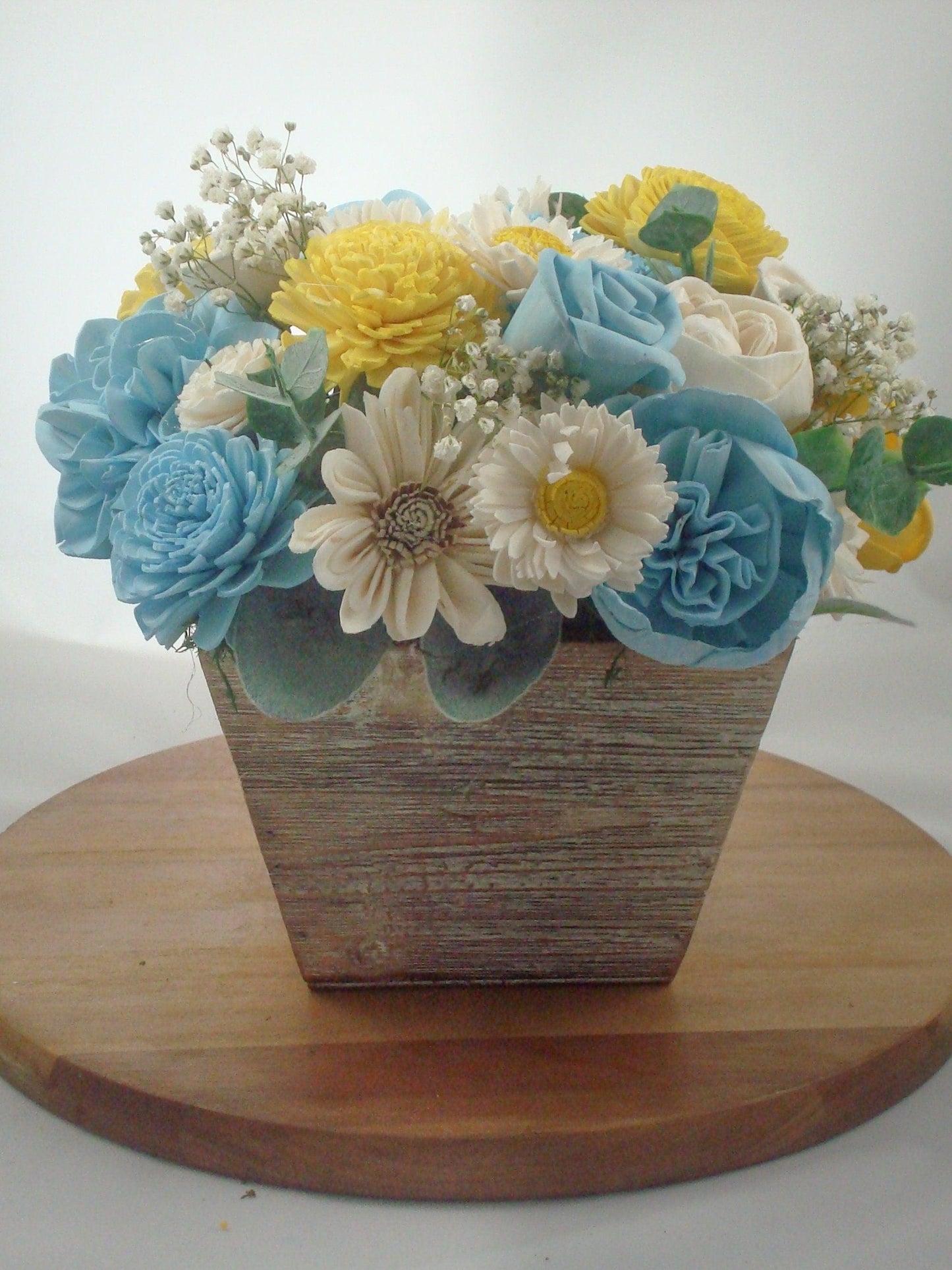 Centerpiece made from Sola flowers in blue and yellow. Perfect for a wedding or your home Keepsake arrangement that lives forever!