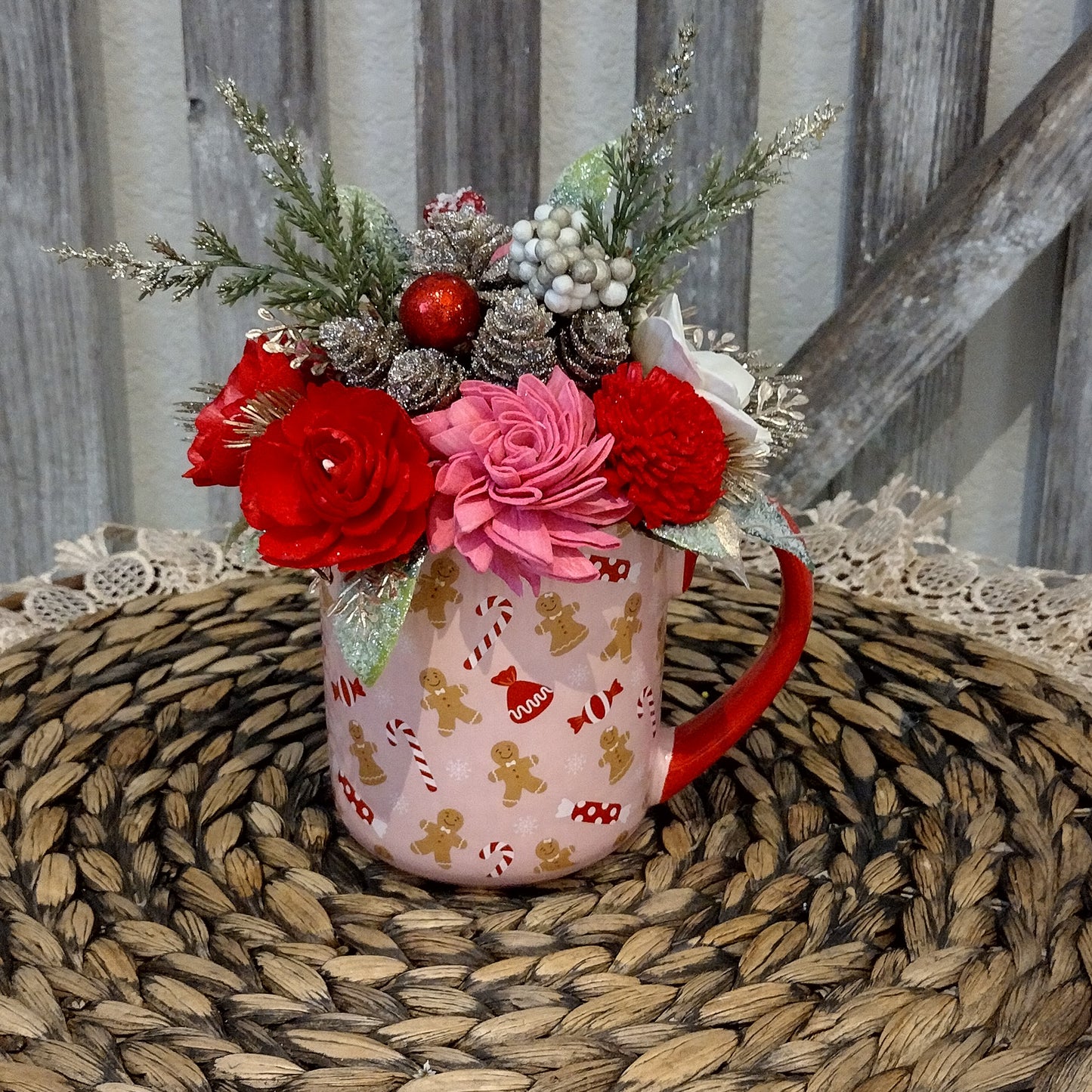 Pink and red holiday mug filled with wood flowers