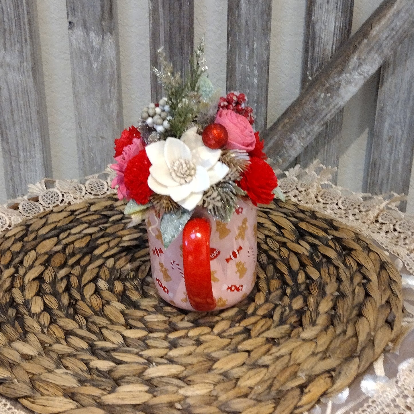 Pink and red holiday mug filled with wood flowers