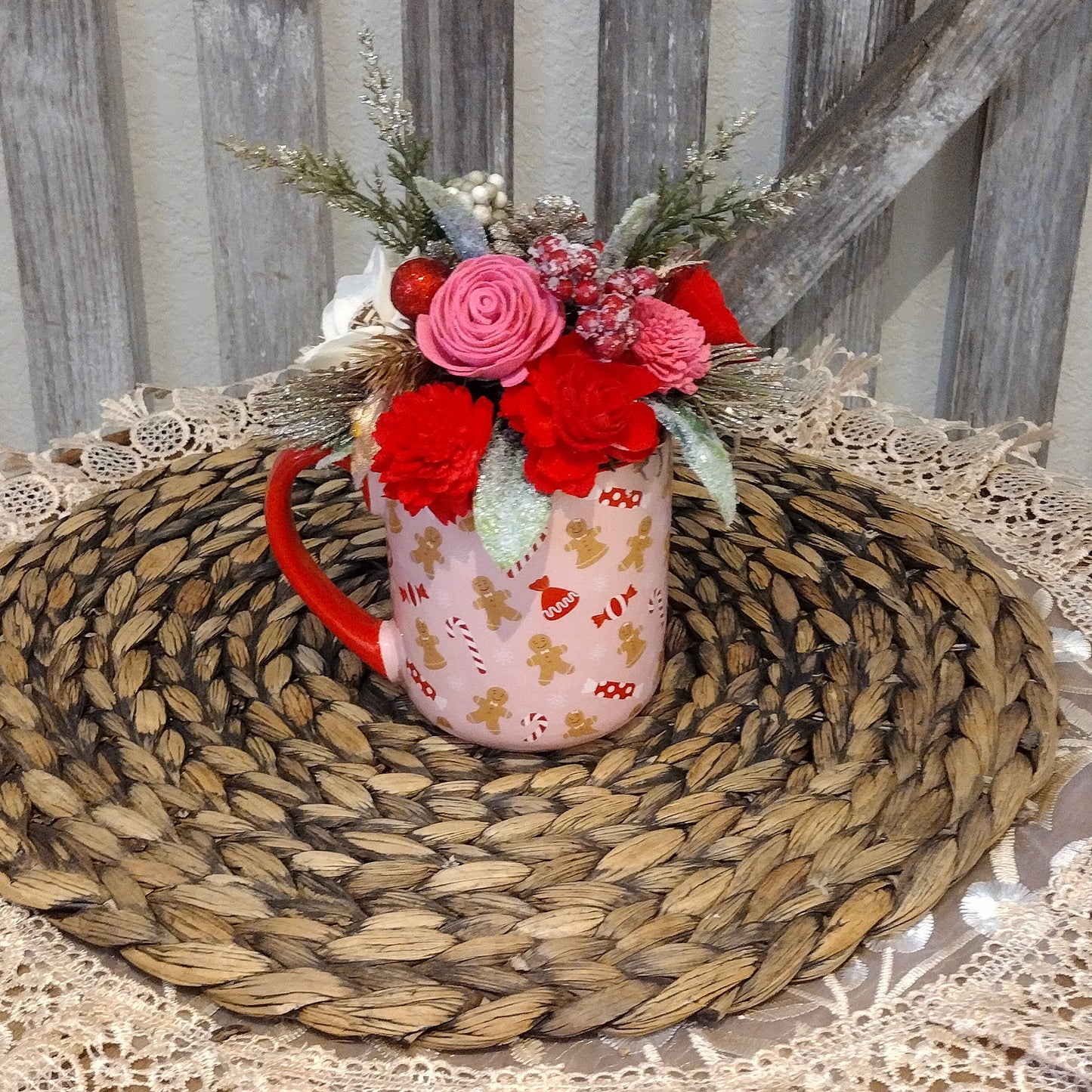 Pink and red holiday mug filled with wood flowers