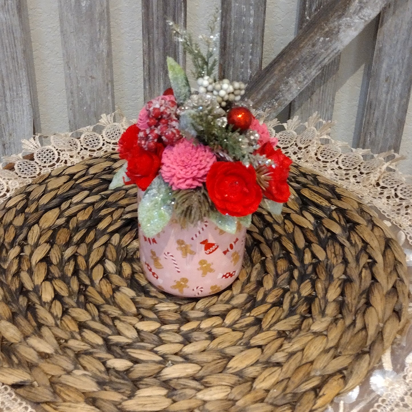 Pink and red holiday mug filled with wood flowers